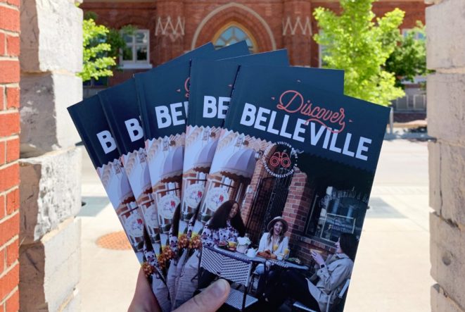 Photo of Discover Belleville guides held up in front of City Hall.