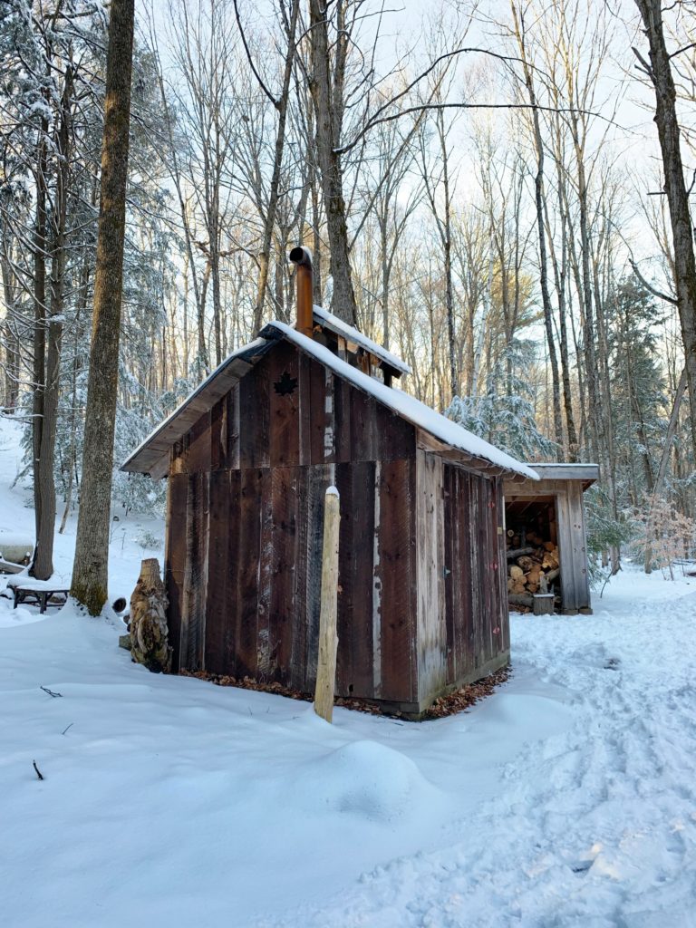 A small wood cabin at H.R. Frink Conservation Area in the winter